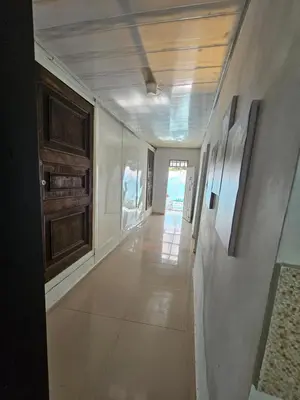a hallway of a building with paintings on the walls at PLAYABRISAMAR in San Antero