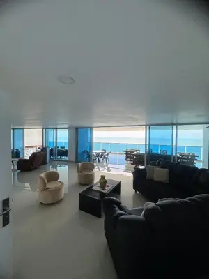 a living room with several couches and a table at Pent House 450 mts 360 front ocean view playa azul in Cartagena de Indias