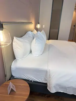 a hotel room with a bed with white pillows at Hotel Sites Barranquilla in Barranquilla