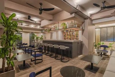a bar with chairs and tables in a restaurant at Hotel Sites Barranquilla in Barranquilla