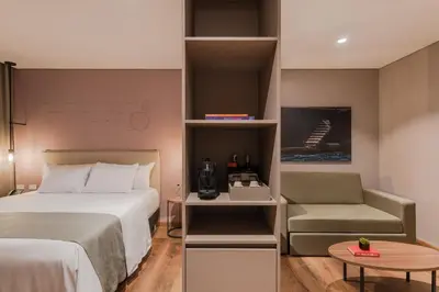 a hotel room with a bed and a chair at Hotel Sites Barranquilla in Barranquilla