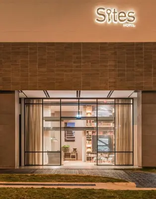 a facade of a building with the entrance to a store at Hotel Sites Barranquilla in Barranquilla