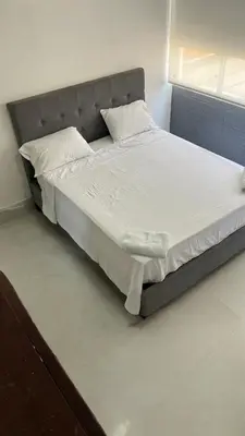 a bedroom with a large bed with white sheets and pillows at Vista Playa in Cartagena de Indias