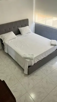 a large bed with white sheets and pillows in a bedroom at Vista Playa in Cartagena de Indias