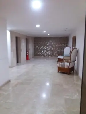 an empty room with chairs and a stone wall at Vista Playa in Cartagena de Indias