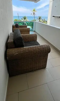 two wicker couches on a balcony with a view of the ocean at Vista Playa in Cartagena de Indias