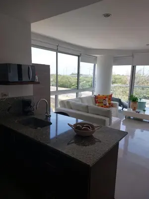 a kitchen and living room with a couch and a table at Apartamento Morros vitri 214 zona norte in Cartagena de Indias