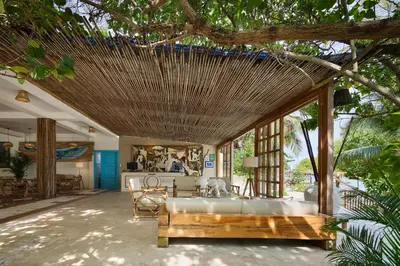 a living room with a bed and a table at Fenix Beach Cartagena in Tierra Bomba