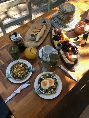 a wooden table with plates of food on it at Fenix Beach Cartagena in Tierra Bomba