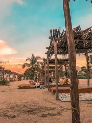 a beach with a wooden structure on the sand at Fenix Beach Cartagena in Tierra Bomba