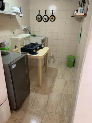 a kitchen with a stove and a table in it at Habitación independiente cerca al mar. in Puerto Salgar