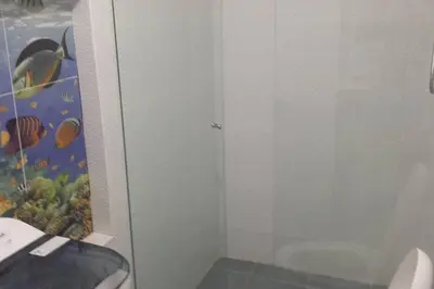 a bathroom with a toilet and a glass door at Fantástica cartagena accesible para todos in Cartagena de Indias