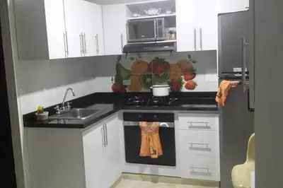 a kitchen with white cabinets and a stove top oven at Fantástica cartagena accesible para todos in Cartagena de Indias
