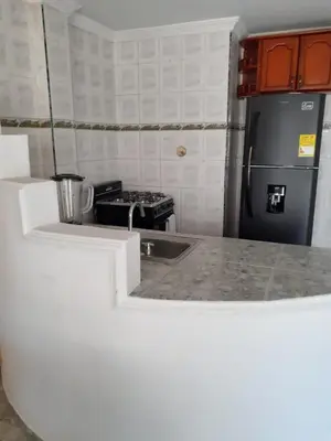 a small kitchen with a sink and a refrigerator at Fantástica cartagena accesible para todos in Cartagena de Indias