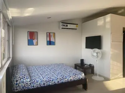 a bedroom with a bed and a fan at Ubicación increíble! cerca del centro y del mar in Cartagena de Indias
