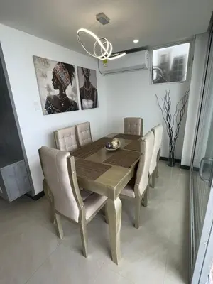 a dining room with a wooden table and chairs at Apartamento Vacacional Cartagena in Cartagena de Indias
