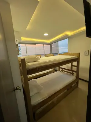 two bunk beds in a room with a window at Apartamento Vacacional Cartagena in Cartagena de Indias