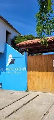 a sign for anatlanticce agency next to a wooden fence at Cabaña El Faro in Tubará