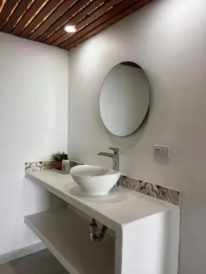a bathroom with a sink and a mirror on the wall at Múcura Club Hotel in Isla Mucura