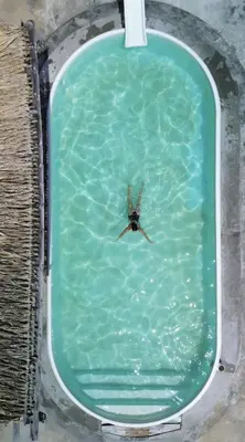 a bird flying over a pool of water at Múcura Club Hotel in Isla Mucura