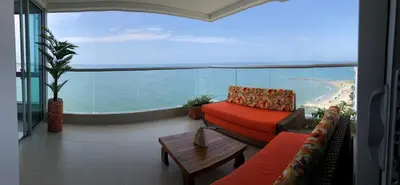 a living room with a couch and a view of the ocean at Apartamento El Laguito Cartagena in Cartagena de Indias
