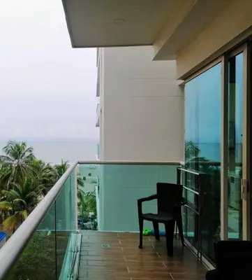 a chair sitting on the balcony of a building at Edificio con piscina frente al mar con Excelente ubicación piso 4 in Cartagena de Indias