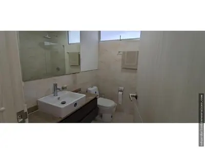 a bathroom with a sink and a toilet and a mirror at Santa Marta Apartamento en Bello Horizonte in Santa Marta
