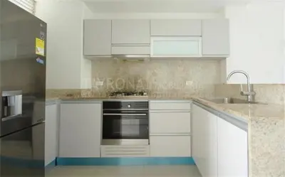 a kitchen with white cabinets and a stainless steel appliance at Santa Marta Apartamento en Bello Horizonte in Santa Marta