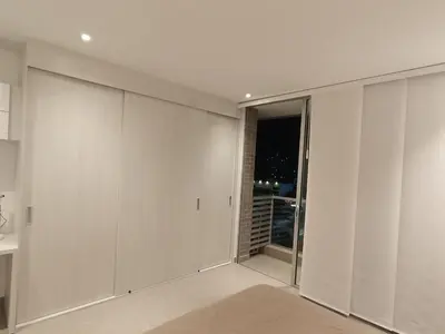 a room with white walls and sliding glass doors at Linda suite in Barranquilla
