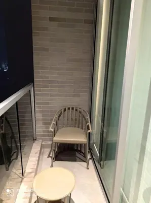 a chair sitting on a balcony next to a table at Linda suite in Barranquilla
