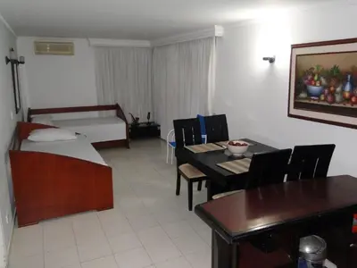 a room with a bed and a table and a dining room at Apartamento en Cartagena Colombia in Cartagena de Indias