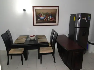 a dining room with a table and a refrigerator at Apartamento en Cartagena Colombia in Cartagena de Indias