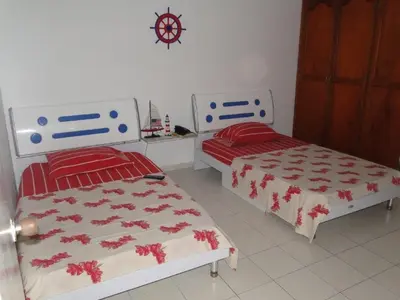 two beds sitting next to each other in a bedroom at Apartamento en Cartagena Colombia in Cartagena de Indias