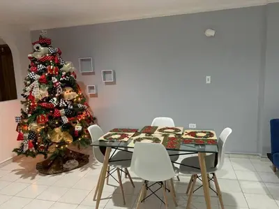 a dining room with a christmas tree and a table and chairs at Apartamento en el Laguito - Cartagena cerca al mar in Cartagena de Indias