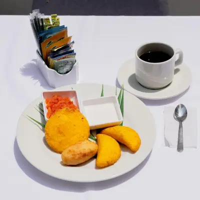 a plate of food on a table with a cup of coffee at Hotel El Marqués De Manga in Cartagena de Indias