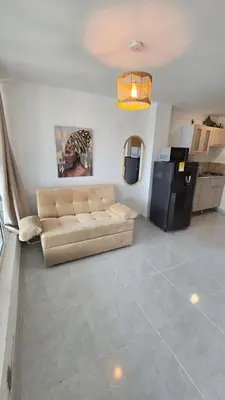 a living room with a couch and a refrigerator at Oceanfront loft in high level neighborhood in Cartagena de Indias