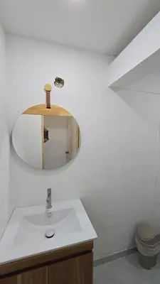 a bathroom with a sink and a mirror at Oceanfront loft in high level neighborhood in Cartagena de Indias