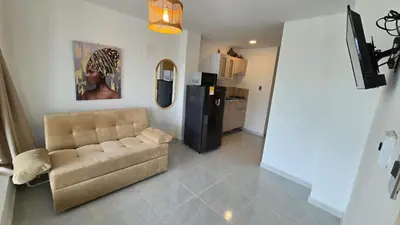 a living room with a couch and a refrigerator at Oceanfront loft in high level neighborhood in Cartagena de Indias