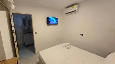 a room with a bed and a tv on the wall at Oceanfront loft in high level neighborhood in Cartagena de Indias