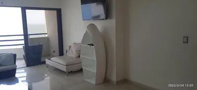 a living room with a chair and a tv on a wall at Modern Duplex Balcony Sea View Mr8 in Cartagena de Indias