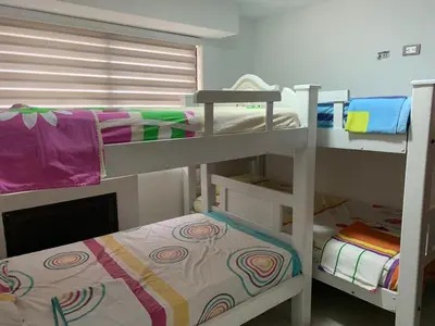 a room with two bunk beds and a bed at Modern Duplex Balcony Sea View Mr8 in Cartagena de Indias