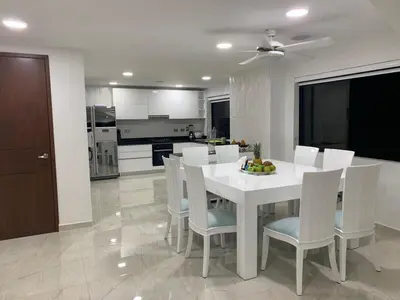 a kitchen and dining room with a white table and chairs at Modern Duplex Balcony Sea View Mr8 in Cartagena de Indias
