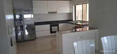 a kitchen with white cabinets and a stove top oven at Modern Duplex Balcony Sea View Mr8 in Cartagena de Indias