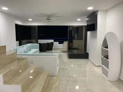 a living room with a blue couch and a living room at Modern Duplex Balcony Sea View Mr8 in Cartagena de Indias