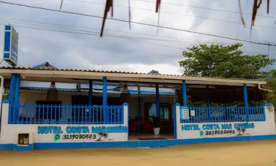 a blue and white building withcriptions on it at Hotel Costa Mar Coveñas in Coveñas