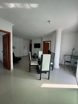 a living room with a table and chairs at Bonito apartamento en Cartagena con garaje gratuito in Cartagena de Indias