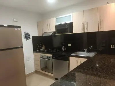 a kitchen with a sink and a stove and a refrigerator at Casa Arcoíris: Espectacular casa en Cartagena con Acceso directo a la Playa in Cartagena de Indias