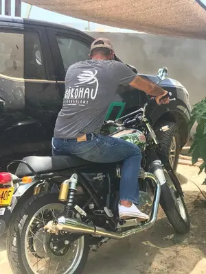a man sitting on top of a motorcycle at KokohauBungalows in Santa Veronica