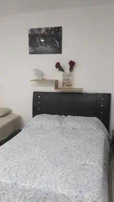 a bedroom with a bed with a white comforter at Edificio NUEVO DE LUJO CARTAGENA BOCAGRANDE in Cartagena de Indias