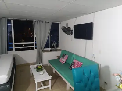 a small living room with a green couch and a table at Excelente vista al mar in Cartagena de Indias